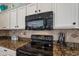 Close up of kitchen appliances and countertops, with granite countertops and white cabinetry at 4266 E Cassia Ln, Gilbert, AZ 85298