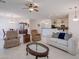 Spacious living room with tile flooring, neutral furniture, and an open floor plan to the dining area at 4266 E Cassia Ln, Gilbert, AZ 85298