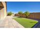 Well-maintained backyard featuring a mix of pavers, artificial turf, and mature trees at 6109 S 30Th Dr, Phoenix, AZ 85041