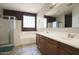 Primary bathroom featuring dual sinks, a soaking tub, a walk-in shower, and tile flooring at 6109 S 30Th Dr, Phoenix, AZ 85041