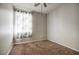 Bedroom featuring neutral paint, carpet, a ceiling fan, and a window allowing natural light at 6109 S 30Th Dr, Phoenix, AZ 85041