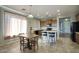 Open concept kitchen with a dining area featuring tile flooring, a center island, and barstool seating at 6109 S 30Th Dr, Phoenix, AZ 85041