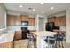 Bright kitchen featuring a center island with bar seating, modern black appliances, and tile flooring at 6109 S 30Th Dr, Phoenix, AZ 85041