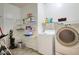 Functional laundry room equipped with washer, dryer, and wire shelving for storage at 6109 S 30Th Dr, Phoenix, AZ 85041