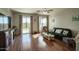 Cozy living room with wood flooring, sliding glass doors to the backyard, and neutral paint at 6109 S 30Th Dr, Phoenix, AZ 85041