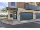 Modern townhome featuring a stylish blue front door and complementing garage doors at 6301 N 12Th St # 14, Phoenix, AZ 85014