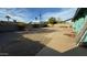 Large backyard with a concrete patio, gravel landscaping, and a block wall fence at 6413 E Holly St, Scottsdale, AZ 85257