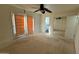 Bedroom with a ceiling fan, sliding doors, and a mirrored closet at 6413 E Holly St, Scottsdale, AZ 85257