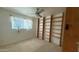 Bedroom with built-in shelving and large window at 6413 E Holly St, Scottsdale, AZ 85257