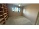 Bedroom featuring natural light and neutral colors, ceiling fan, door and a large window at 6413 E Holly St, Scottsdale, AZ 85257