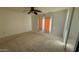 Bright bedroom featuring a ceiling fan, sliding doors, and neutral walls at 6413 E Holly St, Scottsdale, AZ 85257