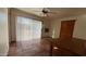 Bright dining room featuring tile floors, sliding glass doors to the backyard, and a ceiling fan at 6413 E Holly St, Scottsdale, AZ 85257