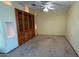 Inviting living room with built-in shelves, carpeted floors, and a ceiling fan at 6413 E Holly St, Scottsdale, AZ 85257