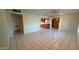 Spacious living room with neutral walls and tile floors, brightened by natural light from the large window at 6413 E Holly St, Scottsdale, AZ 85257