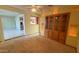 Cozy living room featuring built-in shelves, carpeted floors, and ample natural light at 6413 E Holly St, Scottsdale, AZ 85257