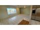 Spacious living room with neutral walls and tile floors, brightened by natural light from the large window at 6413 E Holly St, Scottsdale, AZ 85257