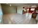 Spacious living room with neutral walls and tile floors, brightened by natural light from the large window at 6413 E Holly St, Scottsdale, AZ 85257