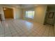 Spacious living room with neutral walls and tile floors, brightened by natural light from the large window at 6413 E Holly St, Scottsdale, AZ 85257