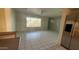 Spacious living room with neutral walls and tile floors, brightened by natural light from the large window at 6413 E Holly St, Scottsdale, AZ 85257