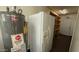 A storage area or utility room with water heater, shelving and refrigerator at 6413 E Holly St, Scottsdale, AZ 85257