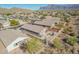 An aerial view showcases this home in a desert community with mountain views at 6589 E Casa De Leon Ln, Gold Canyon, AZ 85118