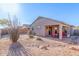 Charming backyard with desert landscaping and a covered patio with outdoor furniture at 6589 E Casa De Leon Ln, Gold Canyon, AZ 85118