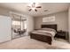 Comfortable bedroom with ceiling fan, sliding glass door, and neutral decor at 6589 E Casa De Leon Ln, Gold Canyon, AZ 85118