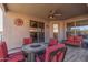 Relaxing covered patio with tiled flooring, a ceiling fan, and comfortable seating around a fire pit at 6589 E Casa De Leon Ln, Gold Canyon, AZ 85118