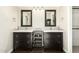 Bathroom featuring double sinks, dark wood cabinetry, and modern lighting at 7345 E Rovey Ave, Scottsdale, AZ 85250