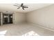 Neutral bedroom featuring an open doorway, ceiling fan, and light carpet at 7345 E Rovey Ave, Scottsdale, AZ 85250