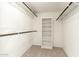 Walk-in closet with white shelving and hanging rods for ample storage space at 7345 E Rovey Ave, Scottsdale, AZ 85250