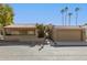 Beautiful single-story home with an attached garage, red tile roof and tidy landscaping at 7345 E Rovey Ave, Scottsdale, AZ 85250