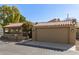 Inviting single-story home featuring a red tile roof, attached garage and manicured landscaping at 7345 E Rovey Ave, Scottsdale, AZ 85250