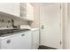 Laundry room with white cabinets, neutral walls, and a washer and dryer set at 7345 E Rovey Ave, Scottsdale, AZ 85250