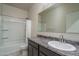 Inviting bathroom with a shower-tub combo and a granite-topped vanity with a large mirror at 7734 W Florence Ave, Phoenix, AZ 85043