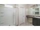 Bright bathroom featuring a shower and a vanity with a sink and decorative mirror at 7734 W Florence Ave, Phoenix, AZ 85043