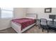 Cozy bedroom with a comfortable bed and a small desk, perfect for a student or a guest at 7734 W Florence Ave, Phoenix, AZ 85043