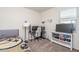 Well-lit bedroom featuring stylish decor and a modern desk setup for gaming or studying at 7734 W Florence Ave, Phoenix, AZ 85043