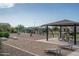 Community playground featuring modern play structures and covered picnic area with BBQ grill for Gathering fun at 7734 W Florence Ave, Phoenix, AZ 85043