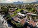 Expansive aerial view showcasing the neighborhood's lush greenery and mountain views at 7920 E Via Camello -- # 49, Scottsdale, AZ 85258