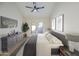 Stylish main bedroom featuring a ceiling fan, dresser, and outdoor access at 7920 E Via Camello -- # 49, Scottsdale, AZ 85258