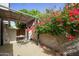 Enchanting private patio area features a table and is embraced by vibrant bougainvillea at 7920 E Via Camello -- # 49, Scottsdale, AZ 85258