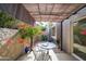 Cozy patio with a table, shade covering and vibrant bougainvillea at 7920 E Via Camello -- # 49, Scottsdale, AZ 85258