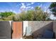 Relaxing outdoor patio area with seating, enclosed by a privacy fence and lush greenery at 7920 E Via Camello -- # 49, Scottsdale, AZ 85258