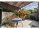 Outdoor patio seating area, accented with a charming table and vibrant bougainvillea at 7920 E Via Camello -- # 49, Scottsdale, AZ 85258