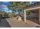 Inviting backyard featuring a built-in grill, stone patio, and meticulously landscaped areas at 800 W Palo Brea Dr, Litchfield Park, AZ 85340