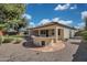 Serene backyard oasis with a built-in BBQ, lush greenery, and a charming covered patio at 800 W Palo Brea Dr, Litchfield Park, AZ 85340