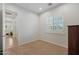 Minimalist bedroom with a neutral color scheme, carpet, and a view of an outdoor patio at 800 W Palo Brea Dr, Litchfield Park, AZ 85340