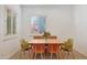 Bright dining area with modern light wood table and stylish chairs near shuttered windows at 800 W Palo Brea Dr, Litchfield Park, AZ 85340