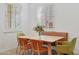 Dining area featuring shuttered windows and a light wood table with colorful chairs at 800 W Palo Brea Dr, Litchfield Park, AZ 85340